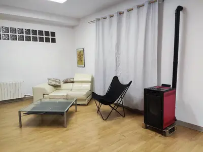 a living room with a couch and a table and a television at Apartamento a 10Km Barcelona, Jardin, Luminoso in Martorellas