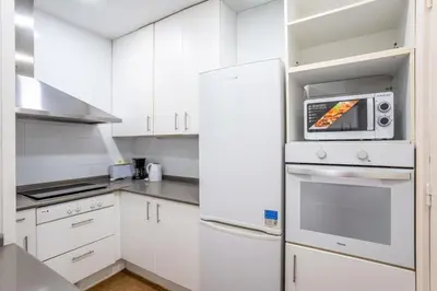 a room with a bench and a window at The Collection Barcelona - Sants Estacio - Modern and comfy 4BD for 8 guests in Barcelona
