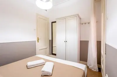 a bedroom with a bed and a wall of lockers at The Collection Barcelona - Sants Estacio - Modern and comfy 4BD for 8 guests in Barcelona