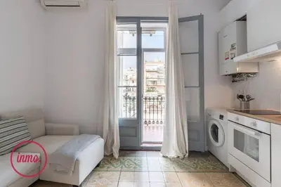 a living room with a couch and a window at Barcelona - Eixample 2 in Barcelona