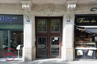 a store front with a large wooden door on a building at Barcelona - Eixample 2 in Barcelona