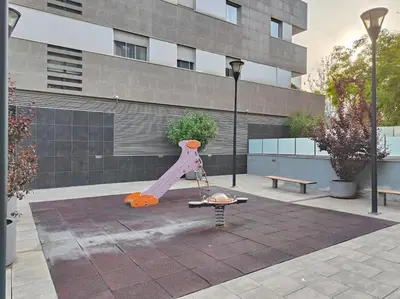 a playground with a slide in front of a building at Cozy apartment Forum beach in Sant Adria de Besos