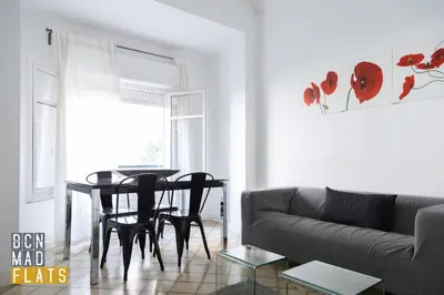 a living room with a table and chairs and a couch at Bcn - Sagrada Familia in Barcelona
