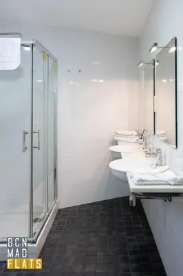 a bathroom with four sinks and a shower at Bcn - Sagrada Familia in Barcelona