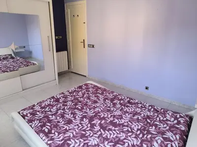 a bedroom with a purple and white blanket on the floor at La casita de Pe Beach in Premiá de Mar