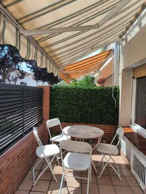 a patio with a table and chairs on a patio at La casita de Pe Beach in Premiá de Mar