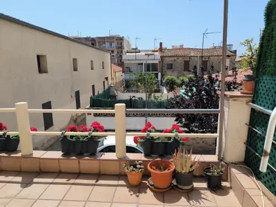 a balcony with a bunch of potted plants at La casita de Pe Beach in Premiá de Mar
