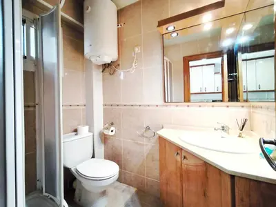 a bathroom with a toilet and a sink and a mirror at Apartamento loft en Castelldefels junto la playa in Castelldefels