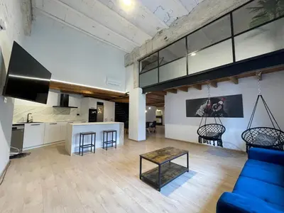 a living room with a blue couch and a table at Manresa industrial home in Manresa
