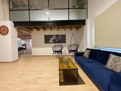 a living room with a blue couch and chairs at Manresa industrial home in Manresa