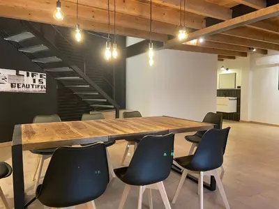 a conference room with a wooden table and chairs at Manresa industrial home in Manresa