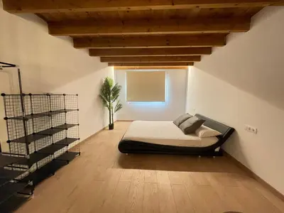 a bedroom with a bed in the corner of a room at Manresa industrial home in Manresa
