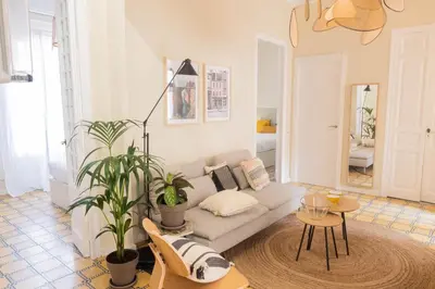 a living room with a couch and a table at Aticco Living Gràcia - Apartments Rooftop in Barcelona