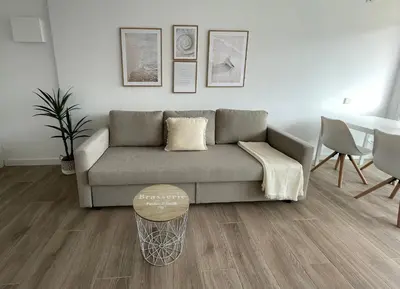 a living room with a couch and a table at Apartment Llavaneres near Barcelona Beach Pool in Sant Andreu de Llavaneres