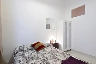 a bedroom with a bed with a pillow on it at Parallel-Patio in Barcelona