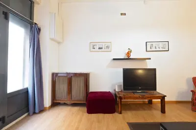 a living room with a television and a coffee table at Parallel-Patio in Barcelona