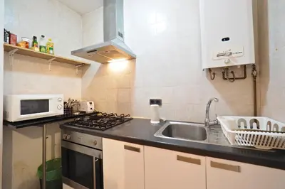a small kitchen with a sink and a microwave at Parallel-Patio in Barcelona