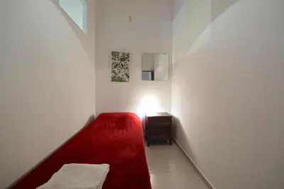 a small room with a red couch and a table at Parallel-Patio in Barcelona