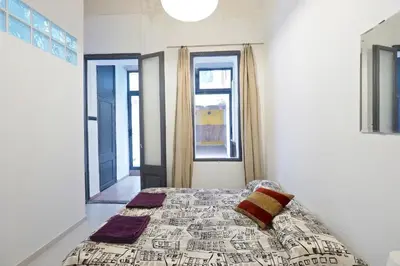 a bedroom with a bed and two windows at Parallel-Patio in Barcelona
