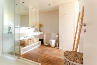 a bathroom with a glass shower and a toilet at APARTMENT JUST 100mts FROM GAUDI'S CASA MILÀ-la Pedrera in Barcelona