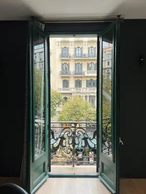 an open glass door looking out at a building at Velvet in Rambla Cataluña in Barcelona