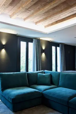 a blue couch in a living room with windows at Velvet in Rambla Cataluña in Barcelona