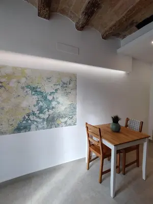 a dining room with a table and a painting on the wall at Antic Manresa 2 in Manresa