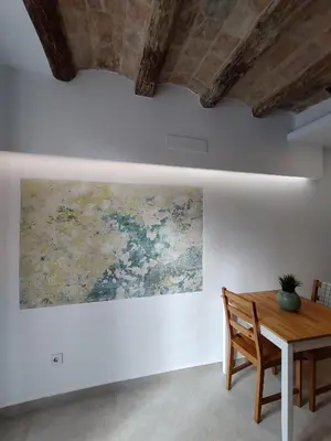 a dining room with a painting on the wall at Antic Manresa 2 in Manresa