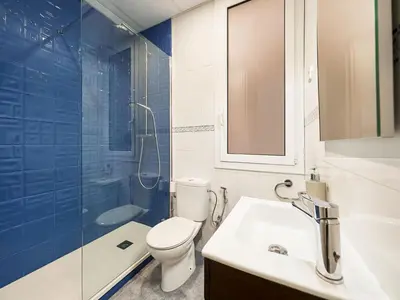 a bathroom with a toilet and a sink and a shower at Belvilla by OYO Rambla Paris Apartment in Barcelona