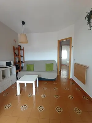 a living room with a couch and a table at Apartamento, 3° línea de playa in Cubelles