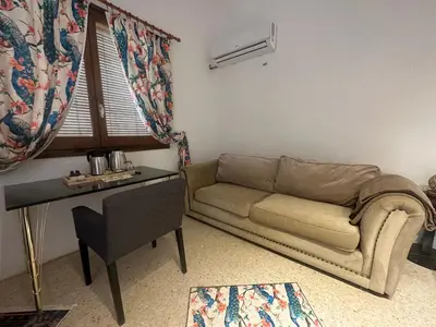 a living room with a couch and a table at Hidden garden Central and quiet rest in Barcelona