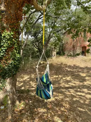 a hammock hanging from a tree in a yard at Hidden garden Central and quiet rest in Barcelona