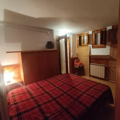 a bedroom with a large bed with a red blanket at Casa Cal Duc, la Garriga in La Garriga