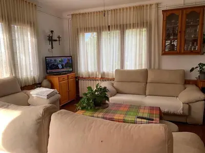 a living room with two couches and a tv at Casa Cal Duc, la Garriga in La Garriga