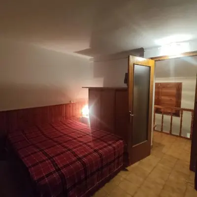 a bedroom with a bed with a red blanket at Casa Cal Duc, la Garriga in La Garriga