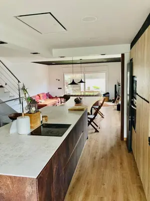 a kitchen with a counter top and a living room at Alma Castellana, Casa en plena Naturaleza in Dosríus