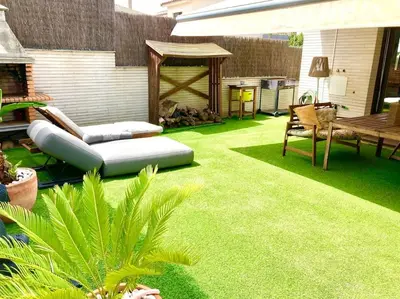 a backyard with green grass and a bench and a table at Alma Castellana, Casa en plena Naturaleza in Dosríus