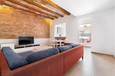a living room with a couch and a brick wall at Space & Privacy Terrace, AC, Central Gràcia in Barcelona