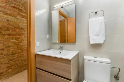 a bathroom with a sink and a toilet and a mirror at Space & Privacy Terrace, AC, Central Gràcia in Barcelona
