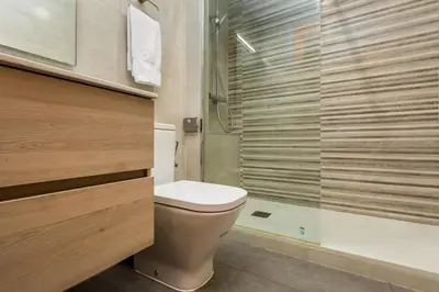 a bathroom with a toilet and a glass shower at Space & Privacy Terrace, AC, Central Gràcia in Barcelona