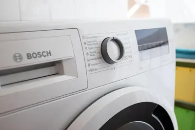 a washing machine with a button on it at Sunny Beachside Haven 2 BD in the Marina District in Barcelona