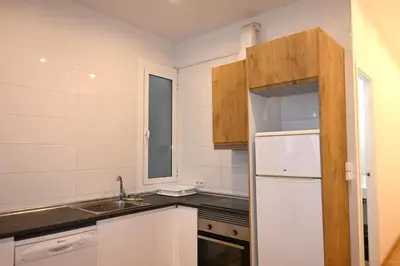 a kitchen with a white refrigerator and a sink at Homenfun Barcelona Paseo de Gracia in Barcelona