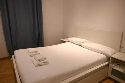 a bedroom with a white bed with towels on it at Homenfun Barcelona Paseo de Gracia in Barcelona