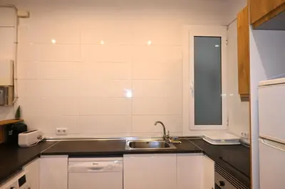a small kitchen with a sink and a window at Homenfun Barcelona Paseo de Gracia in Barcelona