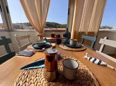 a dining room table with a table cloth on it at Apartamento “La Caleta” in Calella