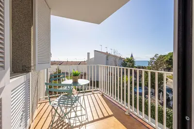 a balcony with a table and a view of the ocean at Hauzify I Apartaments Can Pi in San Pol de Mar