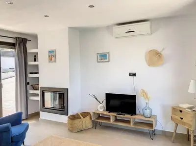 a living room with a tv and a fireplace at Villa Barcelona en Olivella in Olivella