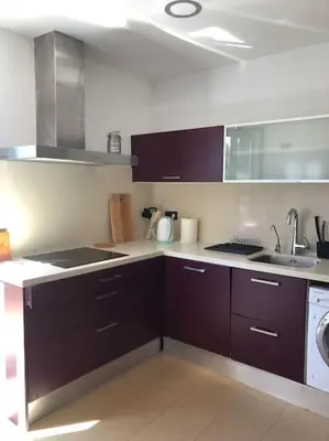 a kitchen with brown cabinets and a sink and a dishwasher at Villa Barcelona en Olivella in Olivella