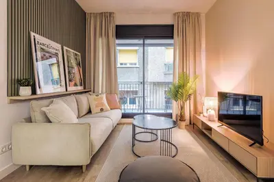 a living room with a couch and a television at CATERINA Gràcia in Barcelona