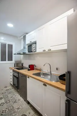 a kitchen with white cabinets and a sink at +25Y ONLY, Family flat near the beach in Barcelona